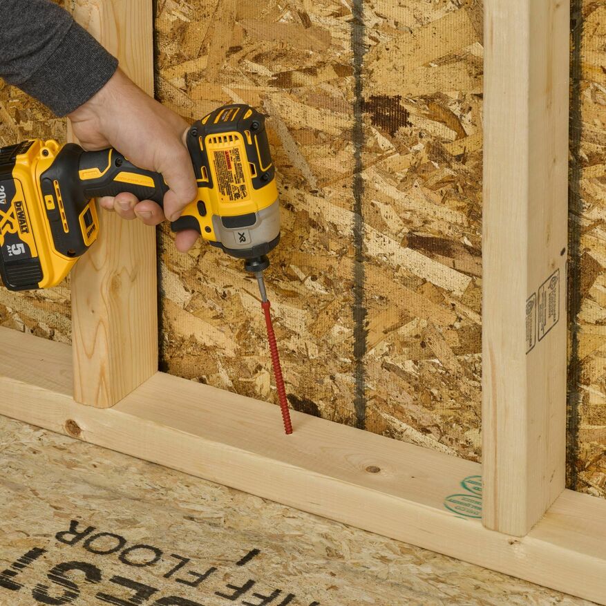 A professional is installing FastenMaster’s FrameFAST framing screw.