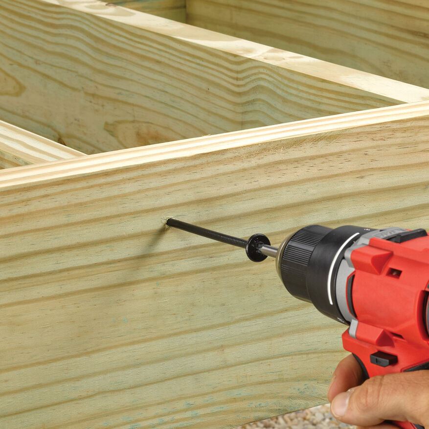 This image depicts a screw being drilled into a piece of wood.